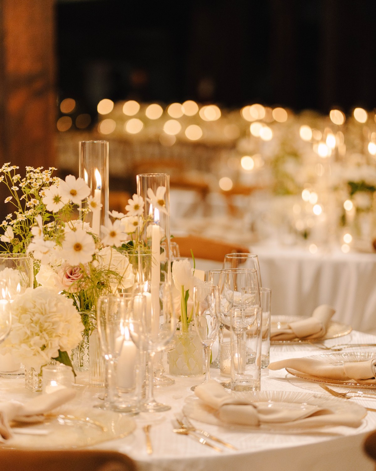 A candlelit tablescape from a KS & Co Events evening, layered florals and tapered candles
